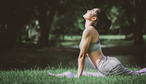Woman doing yoga in the woods